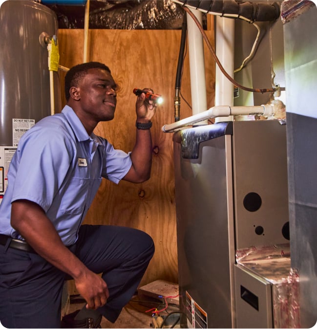 repairman looking at furnace